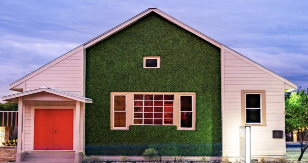 Commercial building with artificial ivy used as a decorative accent on the exterior of the building demonstrates the creativity ofArtificial Turf and Ivy for Commercial Properties .