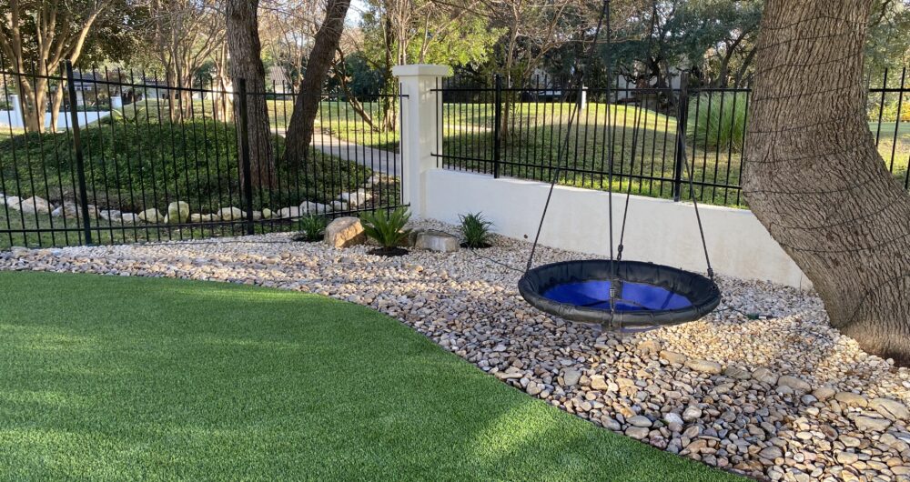 Artificial grass under a shade tree by Ultimate Turf Solutions in San Antonio